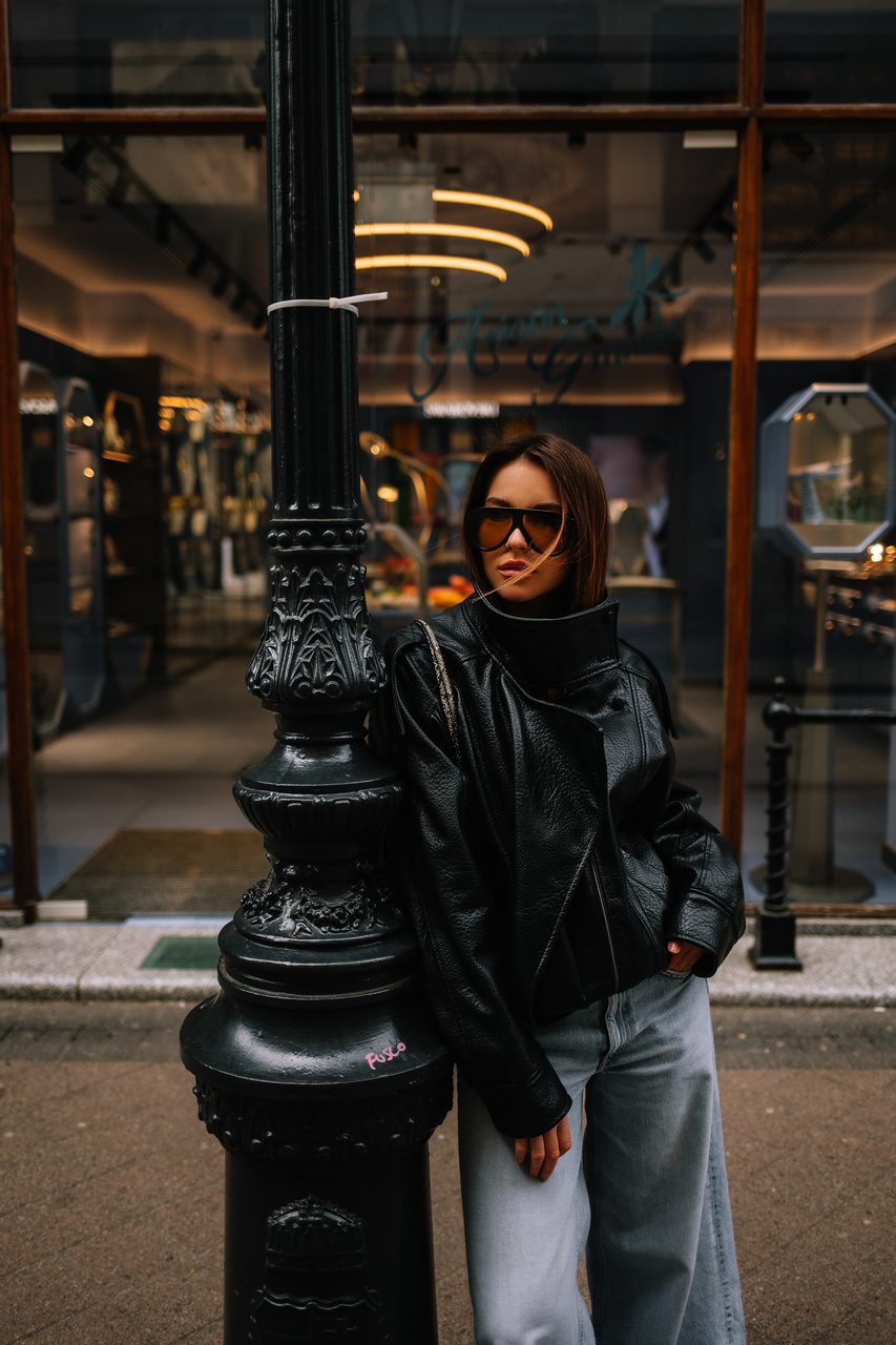 Urban fashion portrait by an ornate lamppost on a Budapest street