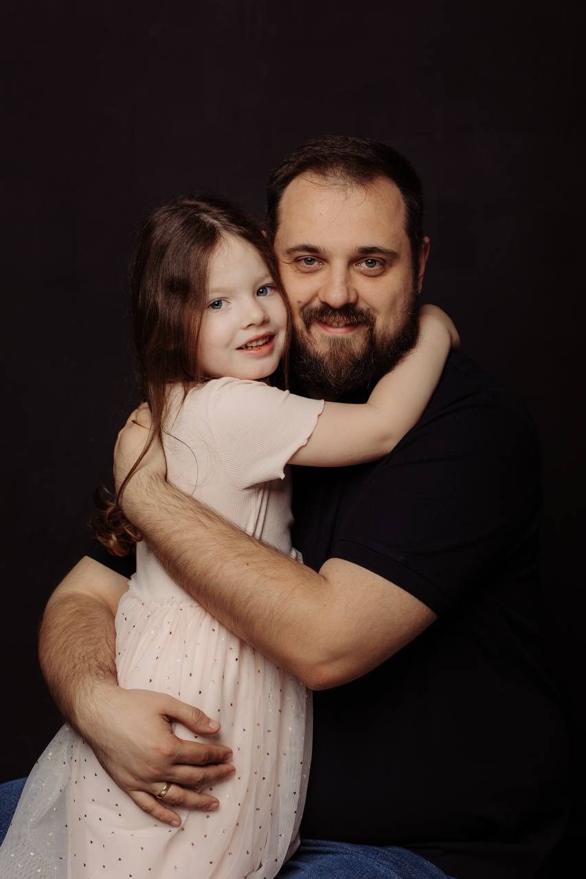 Studio portrait of a father embracing his daughter — family photographer in Budapest